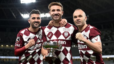 Vissel Kobe players Sergi Samper, centre, David Villa, left, and Andres Iniesta, right, pose with the Emperor's Cup. Getty Images