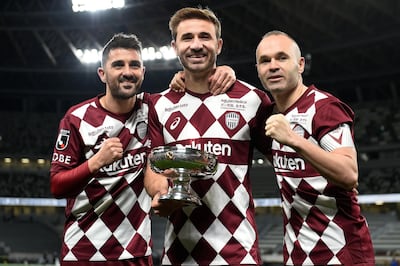 Vissel Kobe players Sergi Samper, centre, David Villa, left, and Andres Iniesta, right, pose with the Emperor's Cup. Getty Images