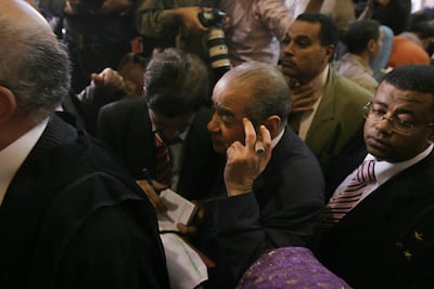 Farid El Deeb holds a cigar as he leaves an Egyptian courtroom in 2008. He died of cancer died aged 79 on Tuesday. Victoria Hazou for The National