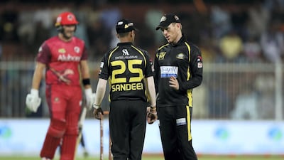 Kerala Knights leg-spinner Sandeep Lamichhane chats with captain Eoin Morgan during their T10 League game against Sindhis in Sharjah on Thursday.