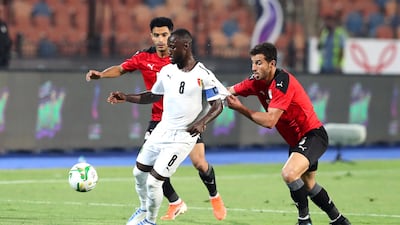 Naby Keita attempts to control the ball under pressure from Omar Gaber and Hamdy Fathy. EPA