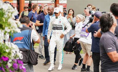Lewis Hamilton arrives at the paddock ahead of the Formula 1 Australian Grand Prix before the event was postponed. EPA