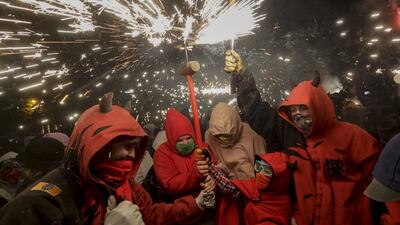 People take part in the traditional 'correfoc' event in Barcelona, Spain. During the event people dress as demons and run through the streets lighting fireworks. EPA