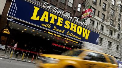 A taxi drives by the Ed Sullivan Theater. EPA
