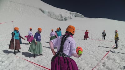 Aymara indigenous women members of the Climbing Cholitas play a football match on the last flat area before heading for the summit.