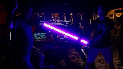 Crew members pose with the light during the filming of 'Jiu Jitsu' in the village of Mammari, on the outskirts of Nicosia, the capital of the east Mediterranean island of Cyprus. AFP