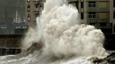 Waves crash into a waterfront wall in Zhangpu in Fujian province. Torrential rain and gale-force winds lashed southern China as Typhoon Megi made landfall after killing at least 48 people as it roared through the Philippines and battered Taiwan.