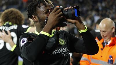 Chelsea's Michy Batshuayi picks up a photographers camera as he celebrates winning the Premier League title. Carl Recine / Reuters