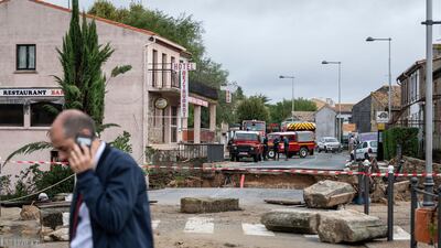 Rescue workers, background, secure the area by a collapsed bridge. AP Photo