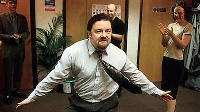 David Brent, played by Ricky Gervais, shows off some dance moves to his co-workers in The Office.