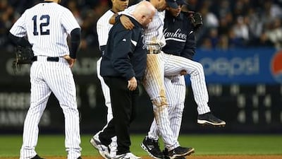 New York Yankees captain Derek Jeter is helped from the field after being injured against Detroit in the opening game of their Championship series