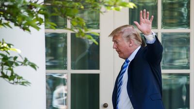 US President Donald J. Trump waves as he walks to the Oval Office during an event in the Rose Garden of the White House in Washington, DC, on May 11, 2018. Shawn Thew / EPA Photo