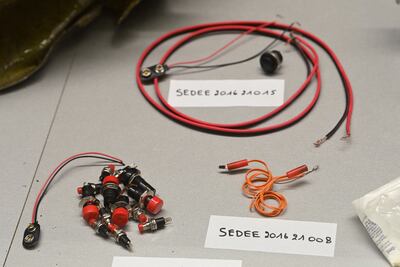 Pieces of evidence are displayed in a case ahead of a hearing in the trial of the 2016 Brussels attacks. Reuters