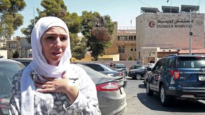 Israa Raed, whose 4-month-old baby girl Malak was removed from the rubble, outside the hospital where her child was receiving treatment. AFP