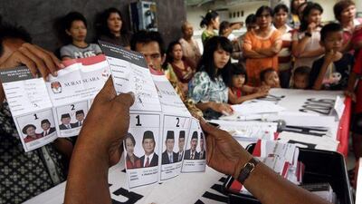 Election officers count ballot papers in Jakarta yesterday. Initial vote counts indicated that Susilo Bambang Yudhoyono had won a second term.