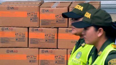 Policewomen walk past boxes with US humanitarian aid goods in Cucuta, on Colombia's border with Venezuela. AFP