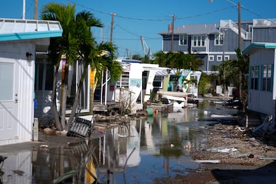The aftermath of Hurricane Milton where debris was still piled outside homes from Hurricane Helene, in Bradenton Beach, Florida. AP