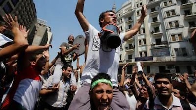 Supporters of deposed Egyptian president Mohammed Morsi protest outside Al Fath Mosque in Ramses Square, Cairo on Friday.