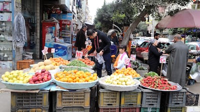 Shoppers at an outdoor food market in Cairo. Egypt's economy has faced several challenges in recent years, including high debt levels, inflation and foreign exchange shortages. EPA