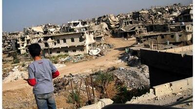 A Palestinian boy looks out at buildings destroyed during the 105-day siege of the Nahr al Bared refugee camp.