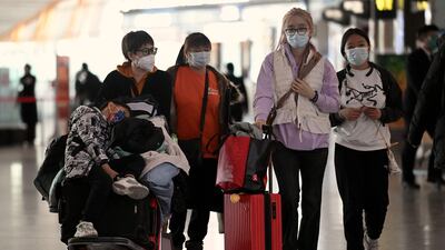 Passengers at a Beijing airport. China is experiencing an increase in Covid case numbers. AFP