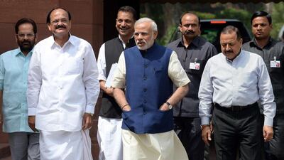 Indian prime minister Narendra Modi arrives at parliament with Ministers of Parliamentary Affairs, Mukhtar Abbas Naqvi (L), Venkaiah Naidu (2L), Rajiv Pratap Rudy (3L) and Jitender Singh (2R) in New Delhi on April 20. AFP Photo