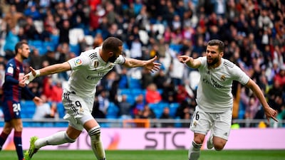 Karim Benzema, left, celebrates with Nacho Fernandez after scoring for Real Madrid against Eibar. AFP