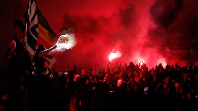 Paris Saint Germain fans with flares outside the stadium during the match against Lens. Reuters