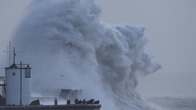 Large waves and high winds associated with Storm Eleanor crash against the lighthouse and seawall at Porthcawl in South Wales. Toby Melville / Reuters
