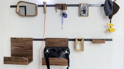 In the entrance foyer is his Hang On wall fitting made of steel, walnut and oak veneers, and mirror. Ruel Pableo for The National