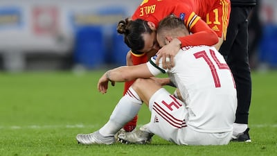 Gareth Bale of Wales consoles dejected Hungary player Gergo Lovrencsics. EPA