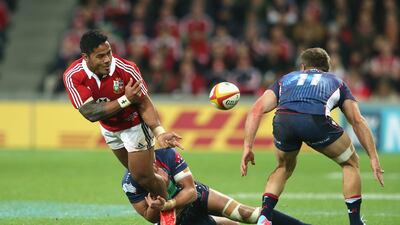Manu Tuilagi, of the Lions, off-loads the ball. David Rogers / Getty Images