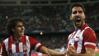 Raul Garcia, right, reacts after his goal for Atletico Madrid on Tuesday. Juan Medina / Reuters