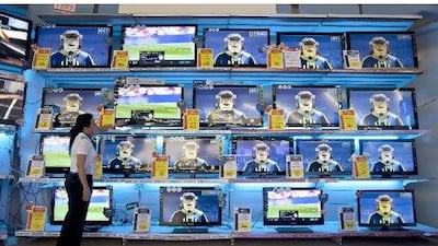 Sales Merchandiser Janet Silayan checks out the TVs in the electronics department in the Carrefour City Center store in Deira.