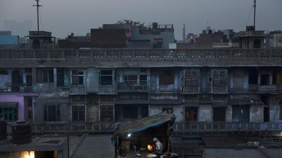 An Indian man prepares flatbread in the old city area of New Delhi. Bernat Armangue / AP Photo