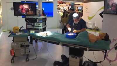 Dr Antonis Pantazis, consultant cardiologist at the Royal Brompton Hospital in London, demonstrates an operation to reduce thickness of heart tissue on an animal heart at the Arab Health Congress on Monday. Nicholas Webster / The National