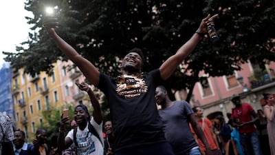 A recently arrived migrant celebrates during a welcoming party organised by neighbourhood groups in Bilbao's old town, Spain. Vincent West/Reuters