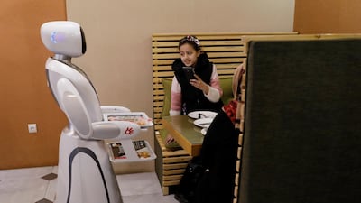 Timea brings food to a table at the Times Fast Food restaurant in Kabul, Afghanistan. Reuters
