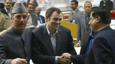National Conference chief Omar Abdullah, centre, is congratulated by senior Congress leader Prithviraj Chavan, right, as former Chief Minister of Jammu and Kashmir Ghulam Nabi Azad looks on in New Delhi.