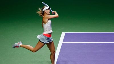 Maria Sharapova returns a shot against Caroline Wozniacki in their match at the WTA Finals on Tuesday. Wozniacki went on to win 7-6 (7/5), 6-7 (5/7), 6-2. Julian Finney / Getty Images / October 21, 2014
