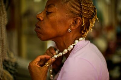 Trying on a collar in a pearl shop in Souq Waqif. AP Photo