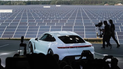 The all-electric Porsche AG Taycan luxury automobile stands on stage as it is unveiled beside the Solarhybrid AG solar park. Bloomberg