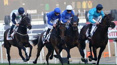 Jockey Richard Kingscote, right, rides Brown Panther to win the Dubai Gold Cup race on Dubai World Cup day at Meydan Racecourse in Dubai on March 28, 2015. AFP PHOTO/KARIM SAHIB