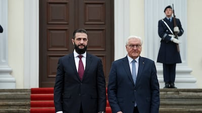 Mr Steinmeier stands alongside Mr Al Shara outside the palace. EPA
