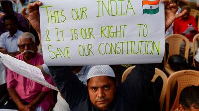 A demonstrator holds a placard to protest against the legislation in Chennai. AFP