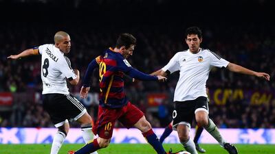Lionel Messi competes for the ball with Sofiane Feghouli. David Ramos / Getty Images