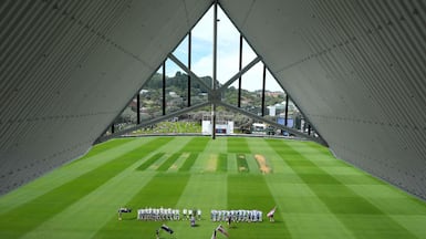 New Zealand's squad, left, and the West Indies team stand for the national anthems on day one of their Test cricket match, in Wellington. AFP