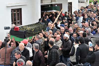 Mourners carry the coffins of a father and his son, who were killed in a collapsed residential building in Tripoli. EPA