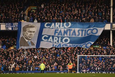 Everton fanbs unfurl a flag of manager Carlo Ancelotti ahead of Saturday's game. AFP