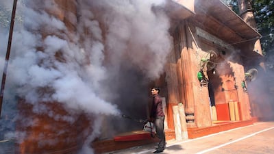 An Indian Municipal Corporation sanitation worker fumigates an area in Old Delhi as part of an anti-dengue fumigation drive to curb breeding sites for mosquitoes causing a dengue outbreak in New Delhi. Rajat Gupta / EPA